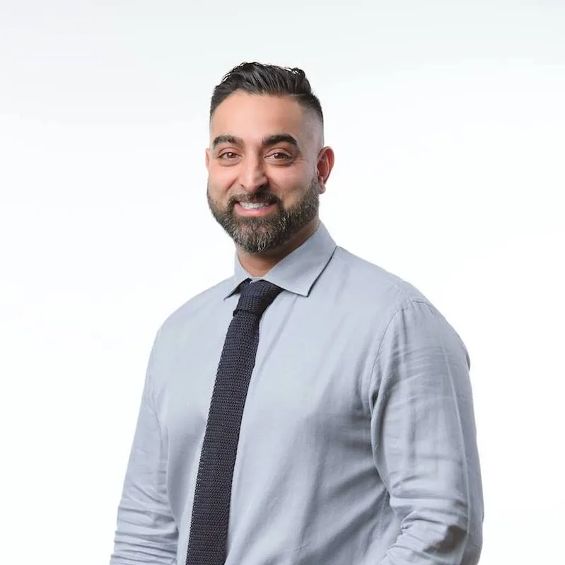 Paul Gill, founder of Real Estate Contractors, in a light blue shirt and dark tie